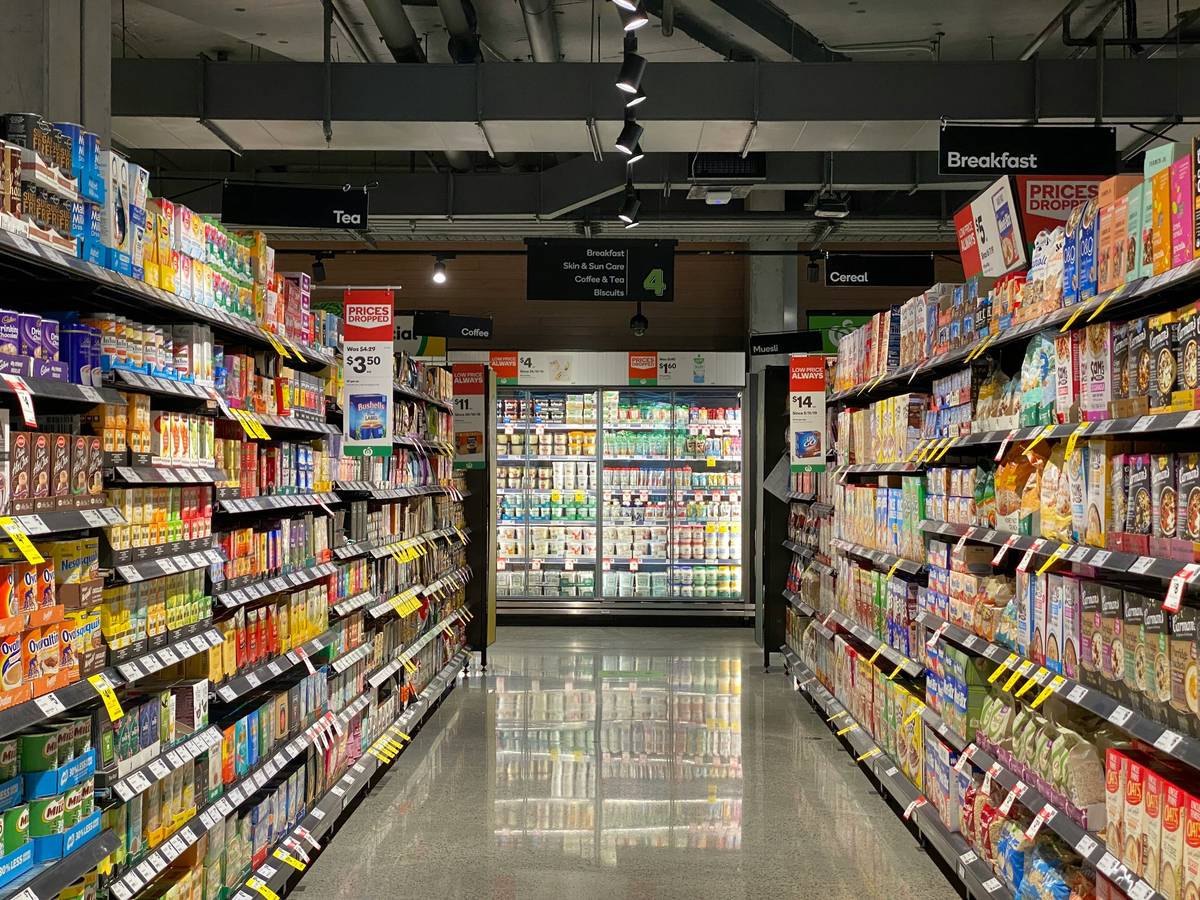 Smart shopper comparing nutrition labels at 99 cent bargains shop